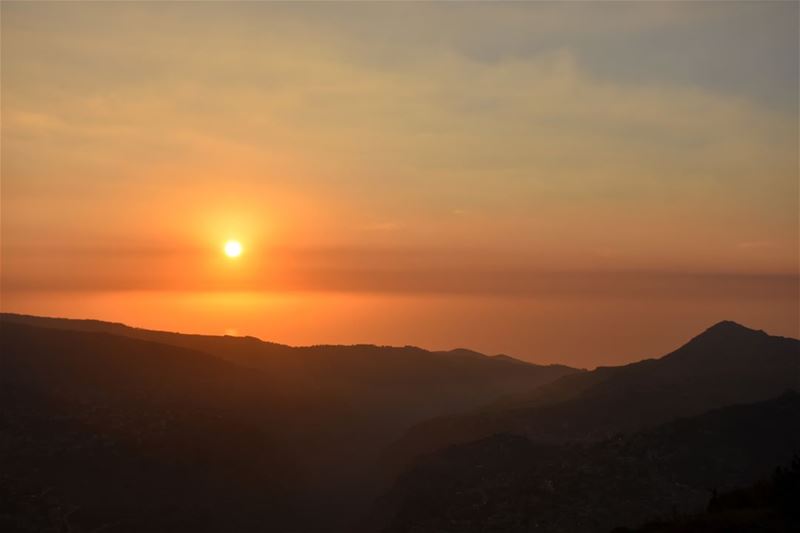 A sunset's orange hues over the mountains of North Lebanon and their... (Bcharreh, Liban-Nord, Lebanon)