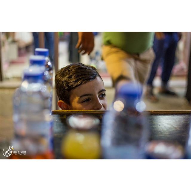 A young kid helping his father on stand in Tripoli souksTripoli is a...