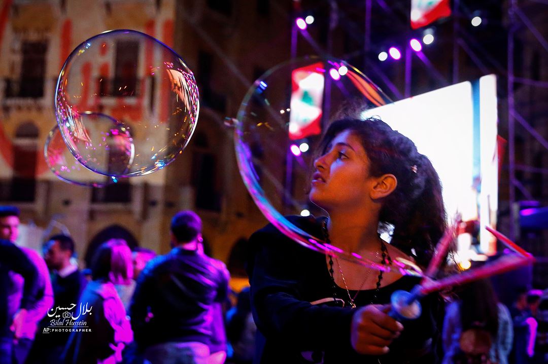 Children blow soap bubbles, during celebrations of Mother's Day in central...
