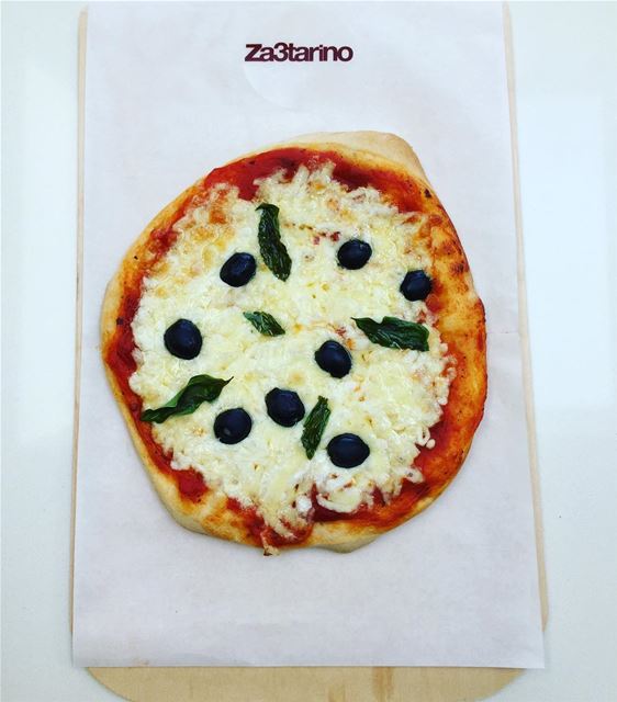 Delicious Pizza with tomato sauce, mozzarella, olives and basil 👌🏻😋💚🍃�