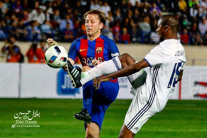 Former FC Barcelona player Gazica Zbala, left, fights for the ball with...