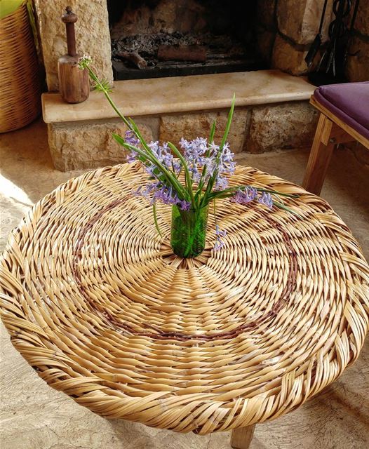 Handmade wicker tabletop and by the fireplace a wooden pestle used to... (Kfarkatra / Chouf)