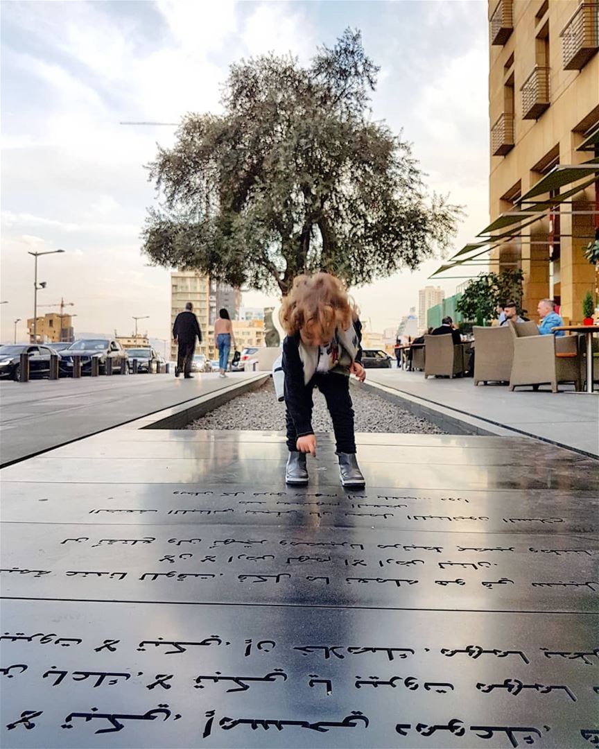 Happy boy jumps on poetic writings in downtown  Beirut by journalist ... (Le Gray, Beirut)