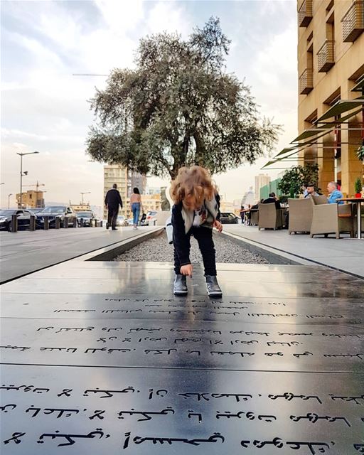 Happy boy jumps on poetic writings in downtown  Beirut by journalist ... (Le Gray, Beirut)