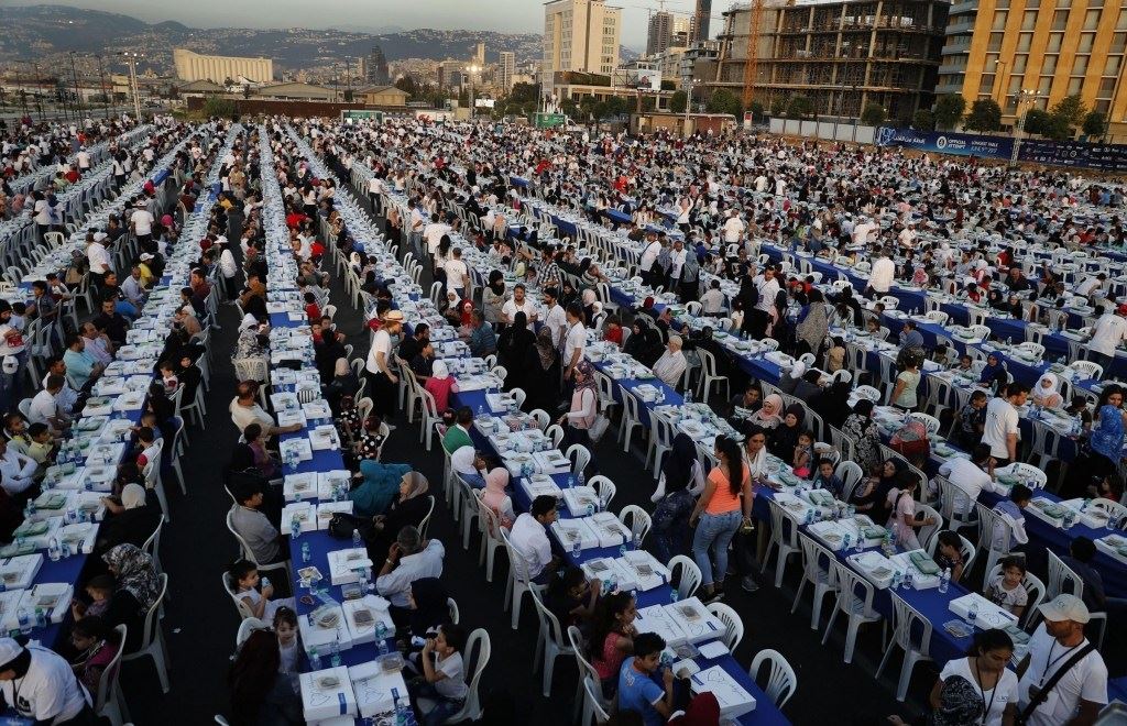 Lebanese citizens, Orphans and Syrian refugees, gather around longest Iftar tables in the world, in Beirut, Lebanon. (Hussein Malla / AP)