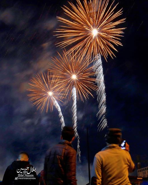 Lebanese watch a firework display during the New Year's celebrations at...