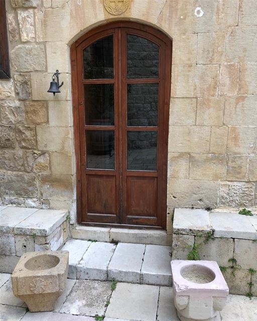 Madame Mimi’s house entrance outflanked with two big stone mortars for...