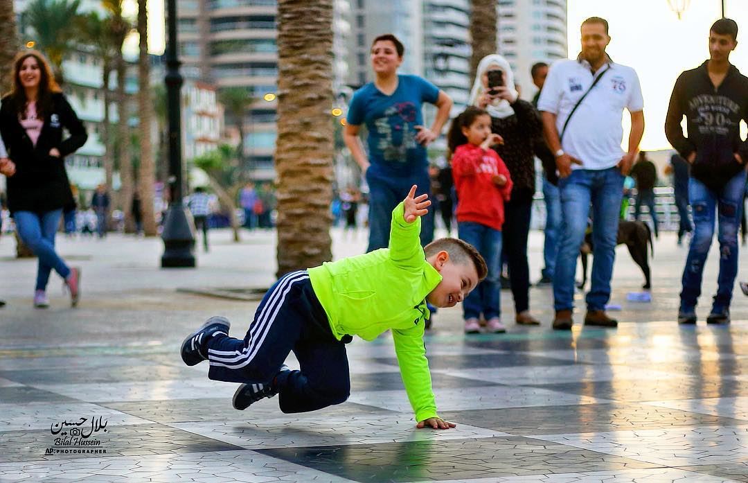 Mahmoud performs a breakdance on the Mediterranean waterfront promenade in...