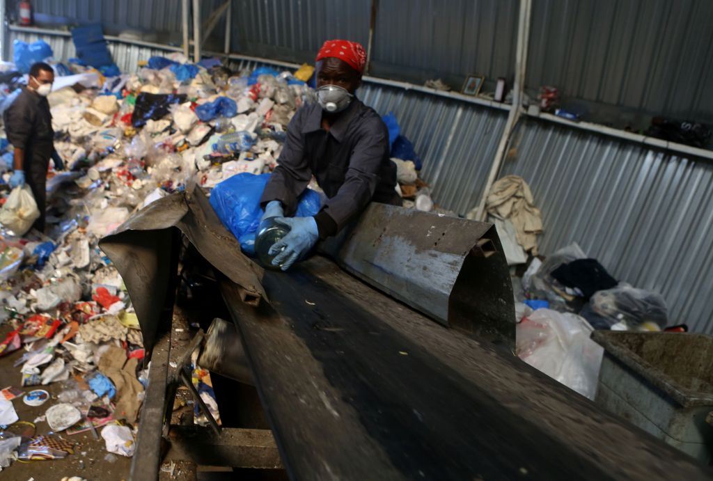Migrant labourers work at a waste recycling plant in Bikfaiya.