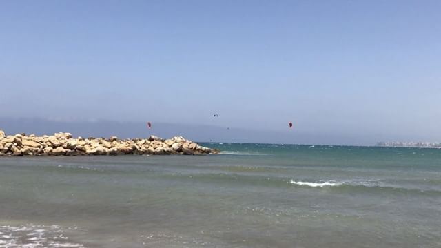 Oh it's definitely blowing wind at Tripoli's north marina  kitesurfers ... (North Marina Beach)