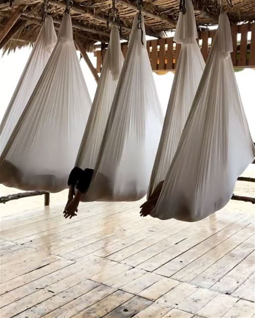 Perfect way to end Aerial Yoga by the sea, wrapped in a cocoon  listening... (C FLOW Beach Resort)