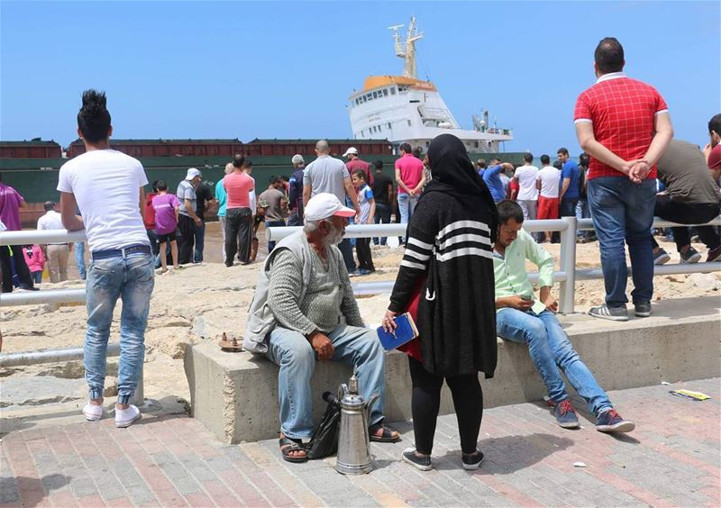 Serving coffee for the spectacle. grounded  ship  saida  people ... (Sidon, Lebanon)