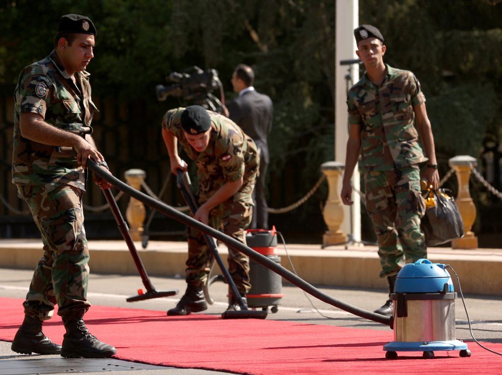 Soldiers Grooming the Red Carpet Prior to the President Arrival