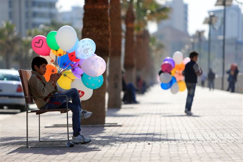 Syrian boys selling balloons along a corniche in Saida, South Lebanon