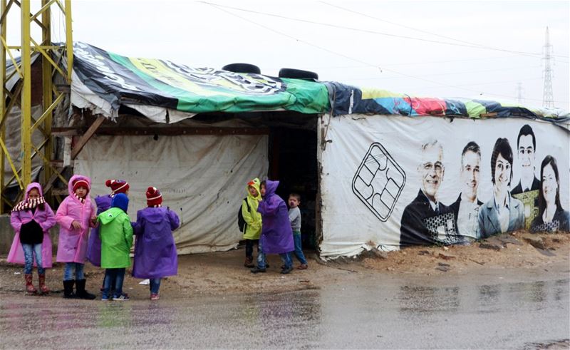 Syrian refugee children play near a tent in Amriyeh in Saadnayel.
