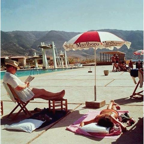 Tabarja 50 Years ago in 1965 , sunbathing leisure never changed, But the mountains behind have been invaded with concrete buildings.