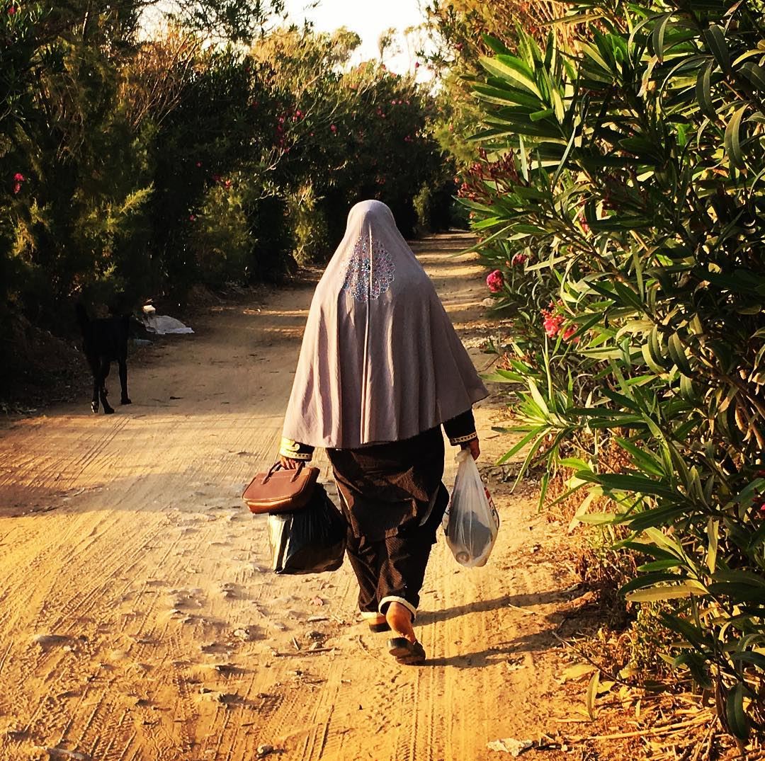 Waking back home trough the orchards  arabwomen  streetphotography ... (Soûr, Al Janub, Lebanon)