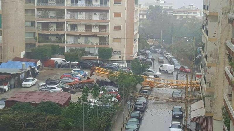 A crane in syoufi near Achrafieh fell because of strong wind damaging cars and balconies near by