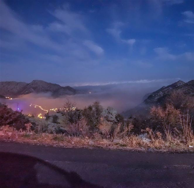 A layer of clouds blankets the sleepy villages below as night sets... (Douma, Liban-Nord, Lebanon)