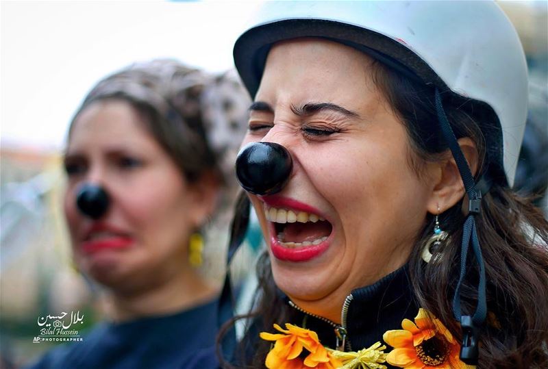 A Lebanese clown wearing refuse cry in jest at a demonstration against the...