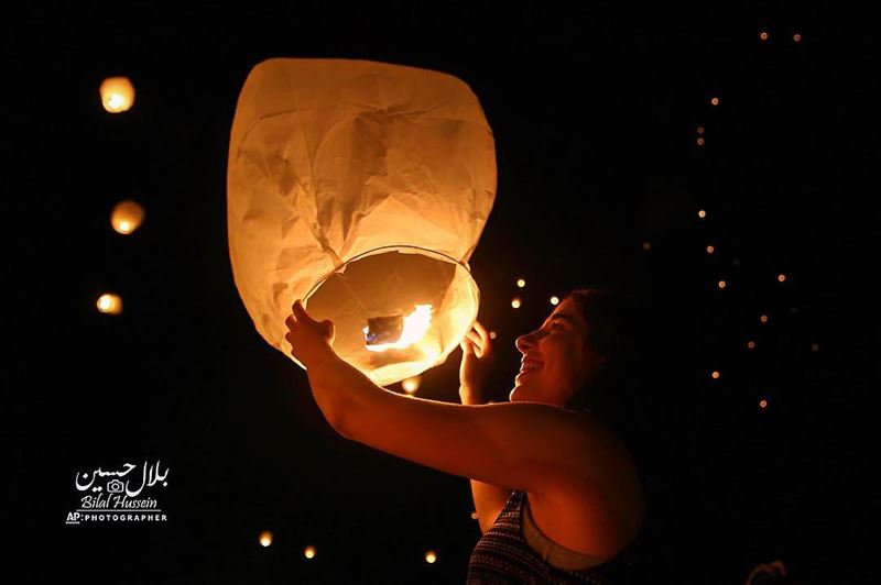 A Lebanese woman releases a paper lantern during Lebanon Lantern Festival...