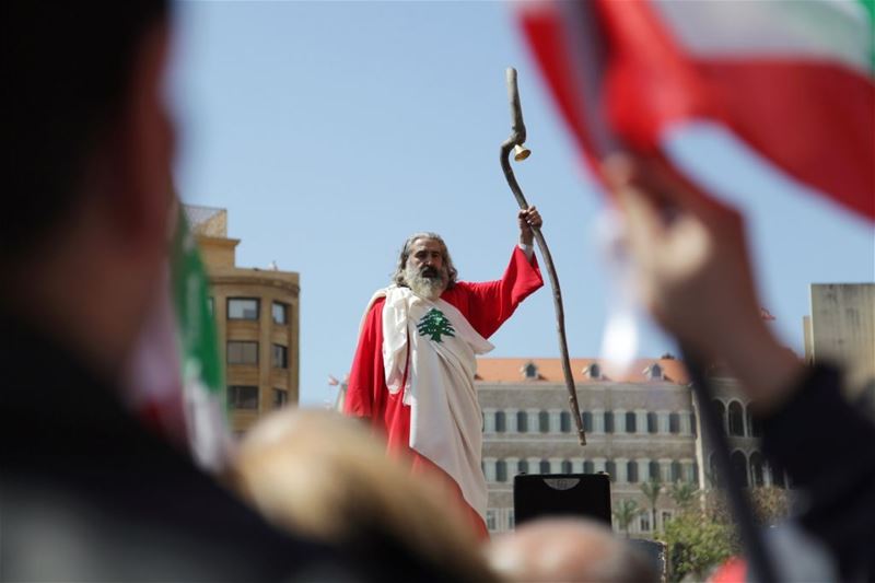 A man dressed up in a Lebanese flag attends a demonstration against proposed tax increase, in Beirut. (Alia Haju / REUTERS) via pow.photos