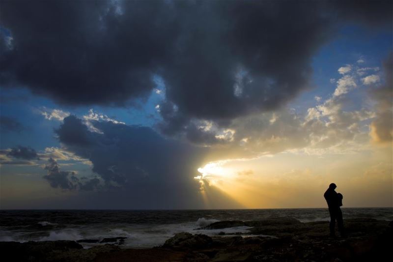 A man reviews pictures on his camera of the Rawcheh Rock, during sunset in Beirut. (Hassan Ammar / AP) via pow.photos