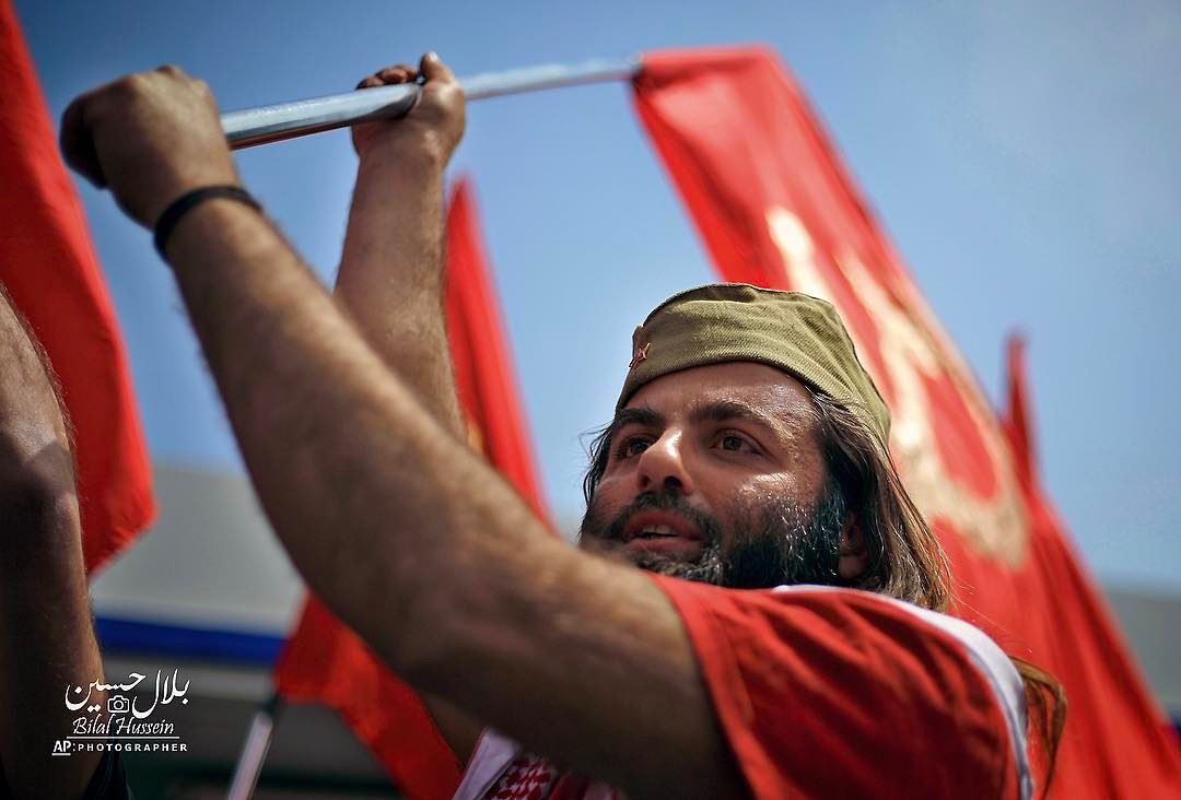 A member of the Lebanese Communist party, waves the party's flag, during a...