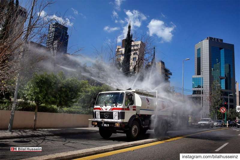 A municipal tanker sprays disinfectant as a precaution against the...