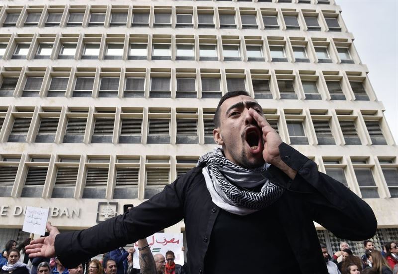 A protest against new high taxes, in front of the Lebanese Central Bank at Hamra Street, in Beirut. (WAEL HAMZEH / EPA) via pow.photos