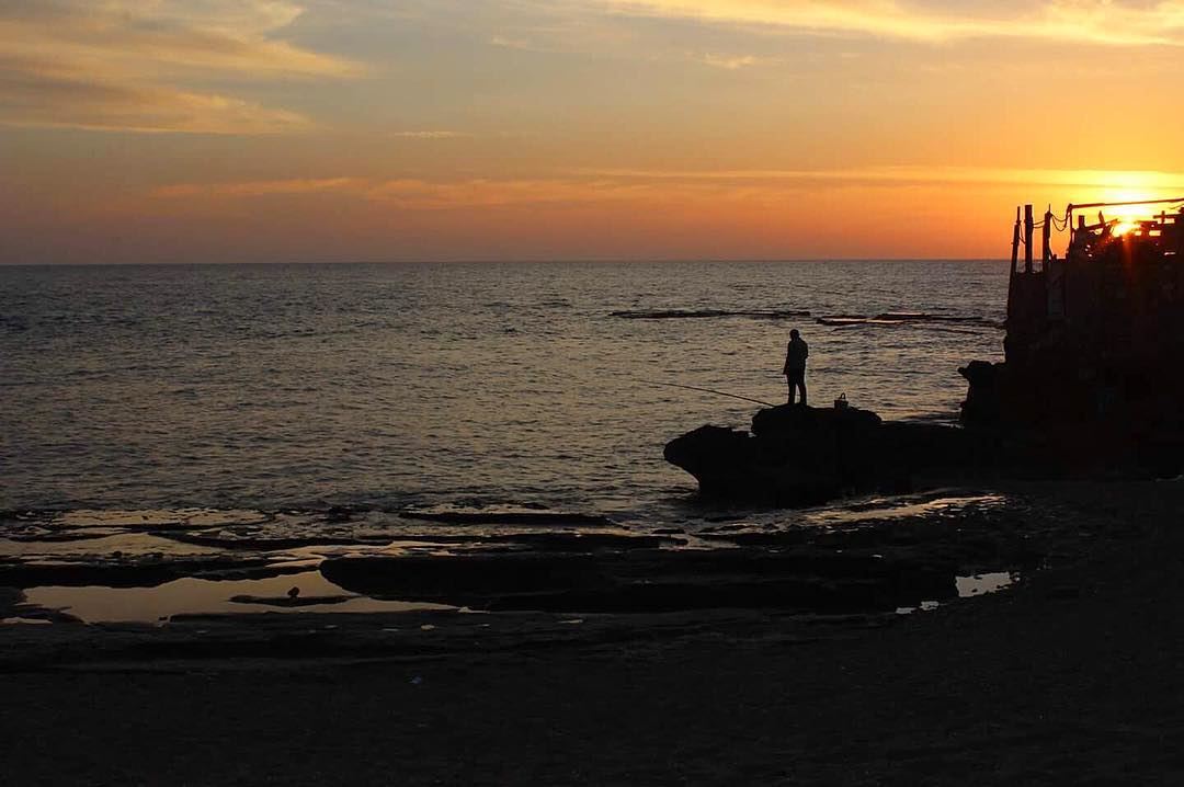 A seashell 🐚.. seachell  sea  sunset  fisherman  lights ... (Tyre, Lebanon)