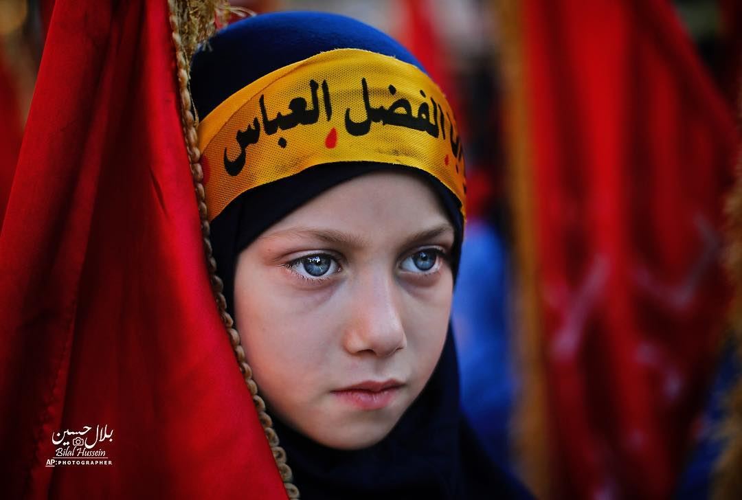 A Shiite Muslim girl attends activities marking the holy day of Ashoura,...