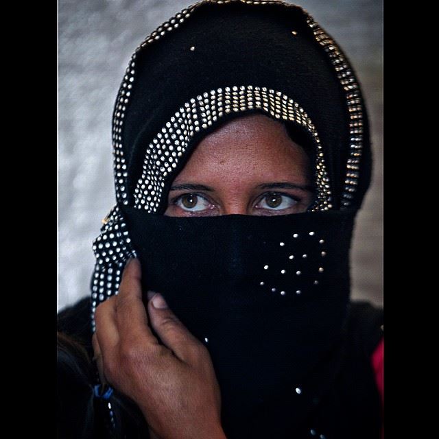 A Syrian refugee woman speaks during an interview with The Associated...