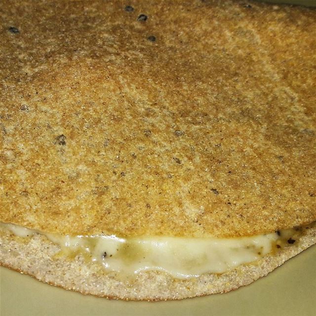 A very thin oatmeal bread stuffed with melted Halloum cheese and... (Tripoli - Abi Samra)