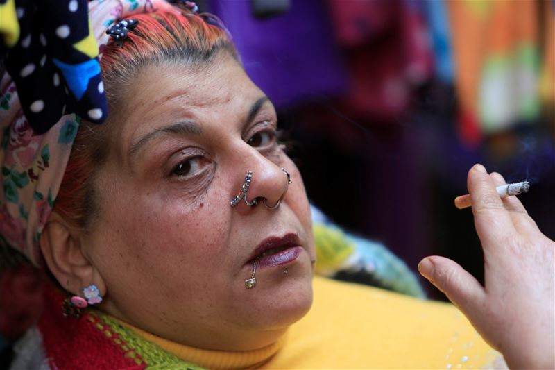 A woman wearing piercings, smokes a cigarette in Sidon, Lebanon. (Ali Hashisho / REUTERS)