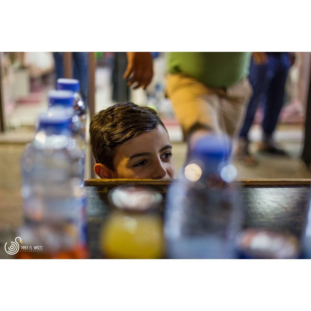 A young kid helping his father on stand in Tripoli souksTripoli is a...