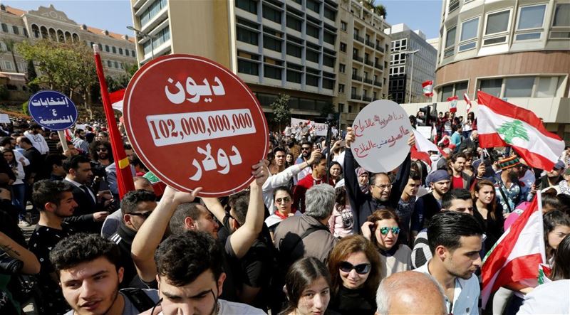 Activists carry placards reading ‘No for more taxes,’ during a protest in Beirut. (NABIL MOUNZER / EPA)  via pow.photos