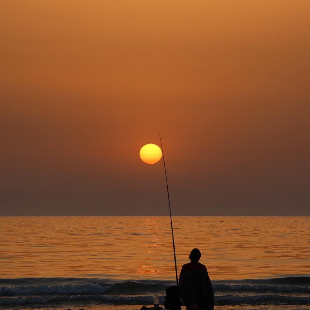 And catch the sun ☀️ ... sunset sunsetlovers sunset_pics fisherman... (Ramlet El Baida Bierut Lebanon)