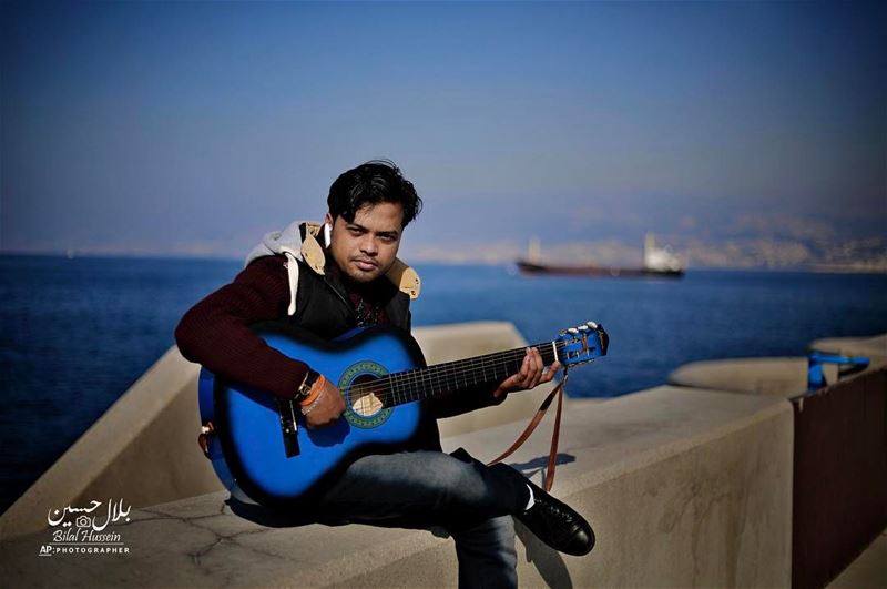 Bangladeshi Mohammed kouton Hassan, plays the guitar as he sitting on the...