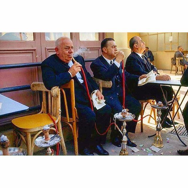 Beirut 1969 - Prosperous Men Smoking Nargileh at the  horse race track and waiting for the results .