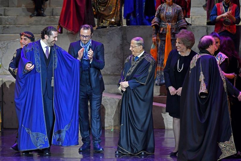 Caracalla performers giving Michel Aoun and Saad Hariri mantles to wear it during the premiere of “Sailing the Silk Road” theater, in Beirut. (Nabil Ismail)