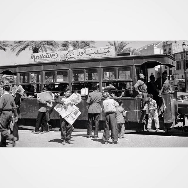 Children selling newspapers near the tramway ,