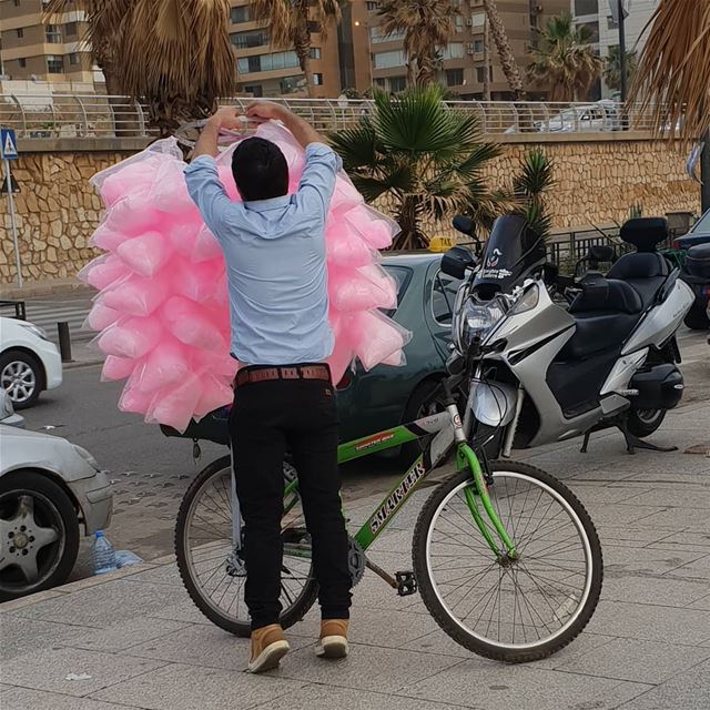 Cotton Candy boy with his green bike. Making summer in Beirut more joyful.... (Ramlat Al Bayda', Beyrouth, Lebanon)