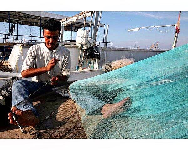 For some it is just a net, for him it is his living.Port of Tripoli,... (Tripoli, Lebanon)
