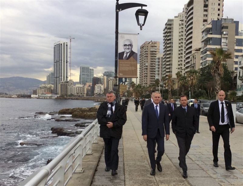 French Foreign Minister Jean-Marc Ayrault, French Ambassador Emmanuel Bonne, walking in Beirut waterfront promenade.