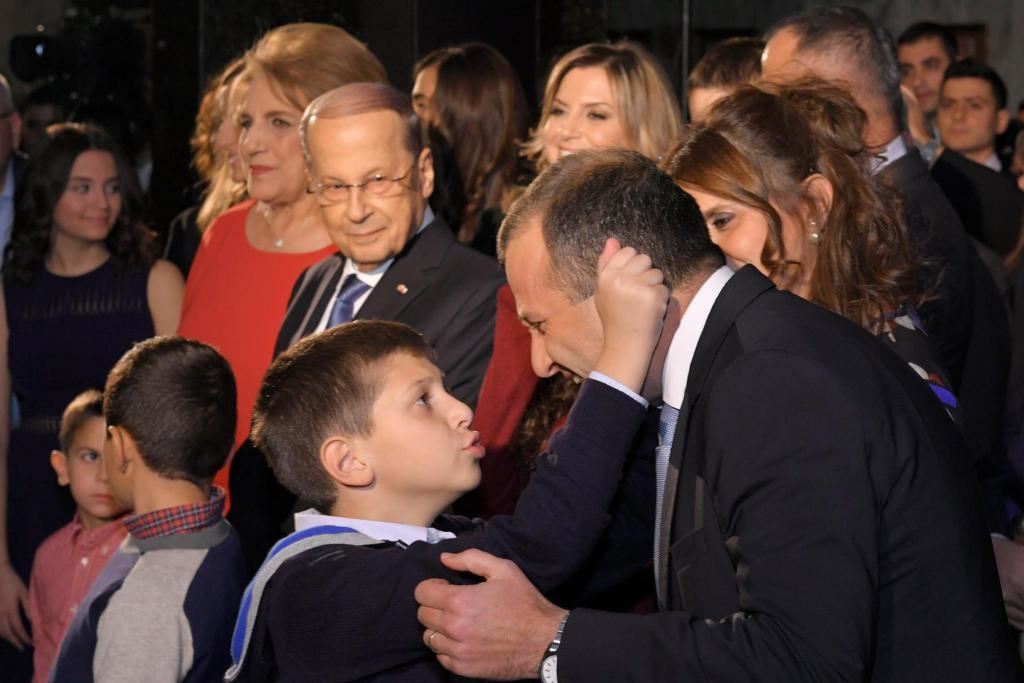 Gabriel pulling his father’s ear Minister Gebran Bassil while standing beside his grandfather President Michel Aoun