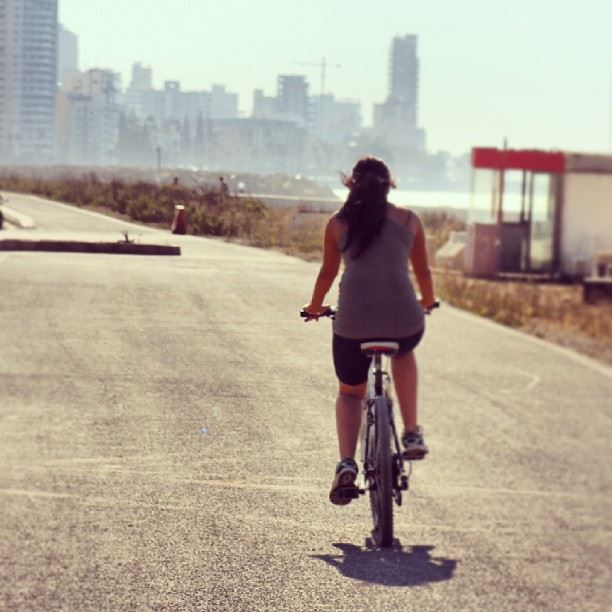  girl  cycle  cycling  road  hair  city  buildings  beirut  lebanon  sea ...