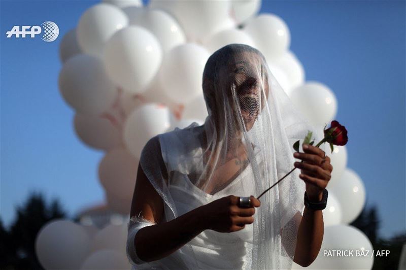 Good morning Beirut. An activist from the NGO Abaad celebrates as the...