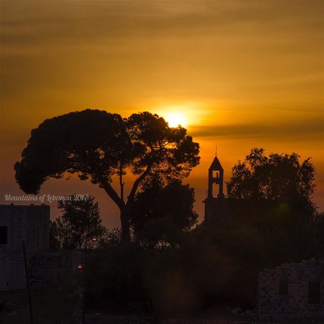 hazy Sunsetting over the bell tower of the Mar Moussi Church at Ballouneh... (Balloûné, Mont-Liban, Lebanon)