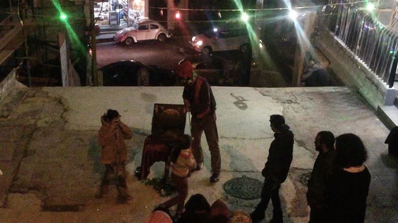 Homeless Children are enjoying a short show by an old man dressed up as a... (Escaliers Vendôme, Mar Mikhael)